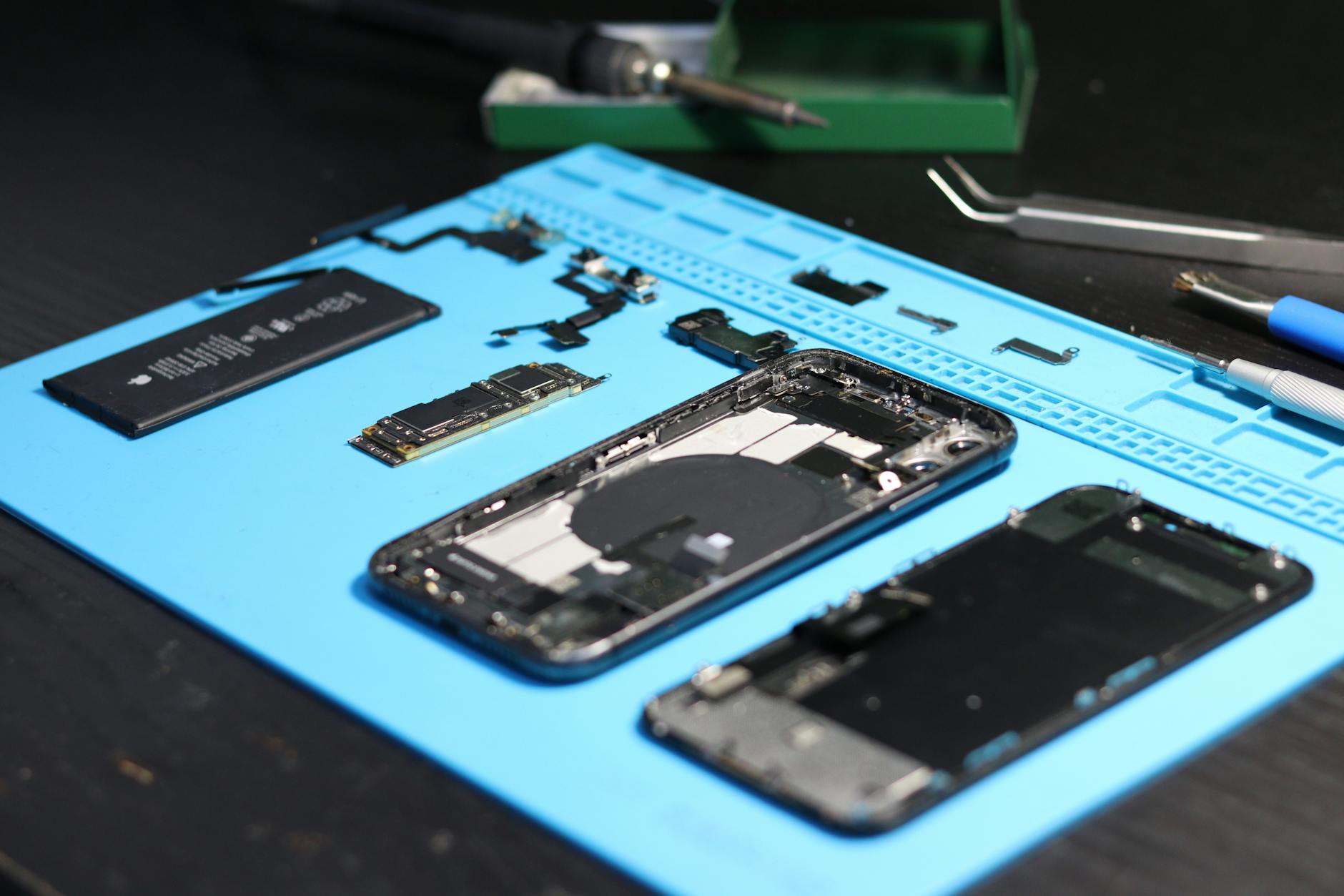 Close-up view of smartphone internal components and circuit boards on a workbench