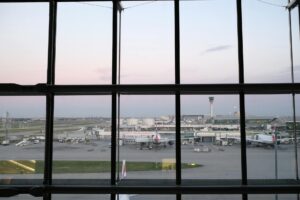 Modern airport terminal interior with passengers and baggage claim area