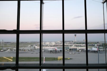 Modern airport terminal interior with passengers and baggage claim area
