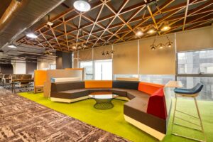 Why Companies Are Installing Sleep Pods in Office Buildings Modern open office space with contemporary furniture and natural lighting where sleep pods might be installed