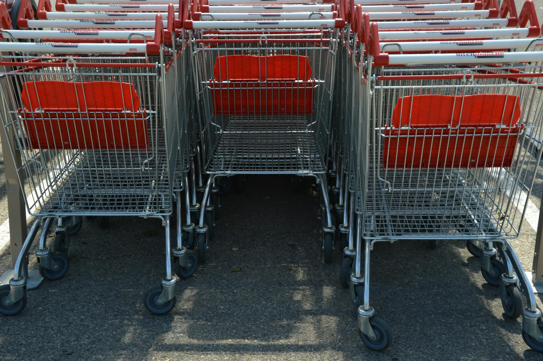 Modern shopping cart in grocery store produce section with digital display