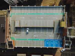 Aerial view of urban parking lot showing potential space for solar canopy installation