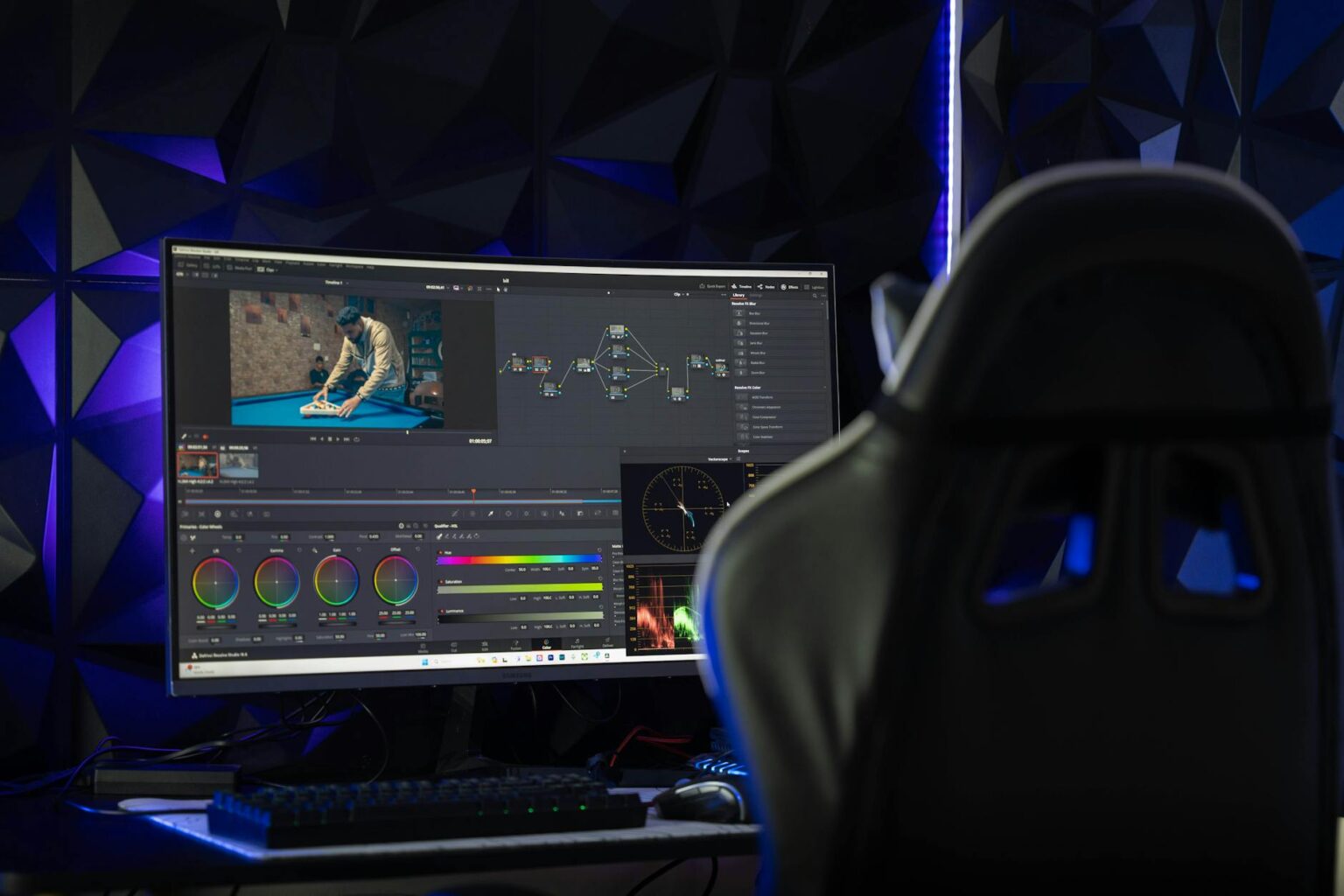 Content creator working on video editing with multiple screens showing YouTube analytics and editing software