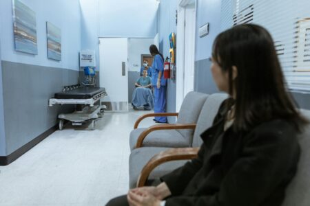 Hospital waiting room with diverse patients and families seeking medical care