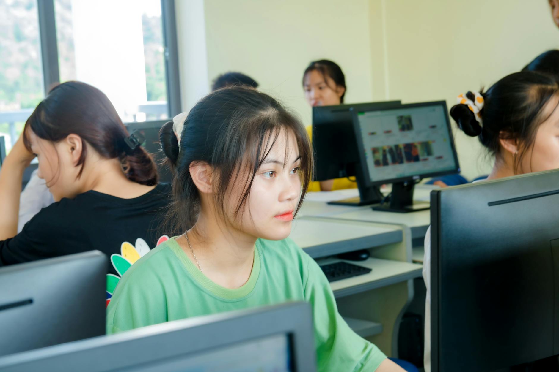 Students working at computers in a university computer science classroom