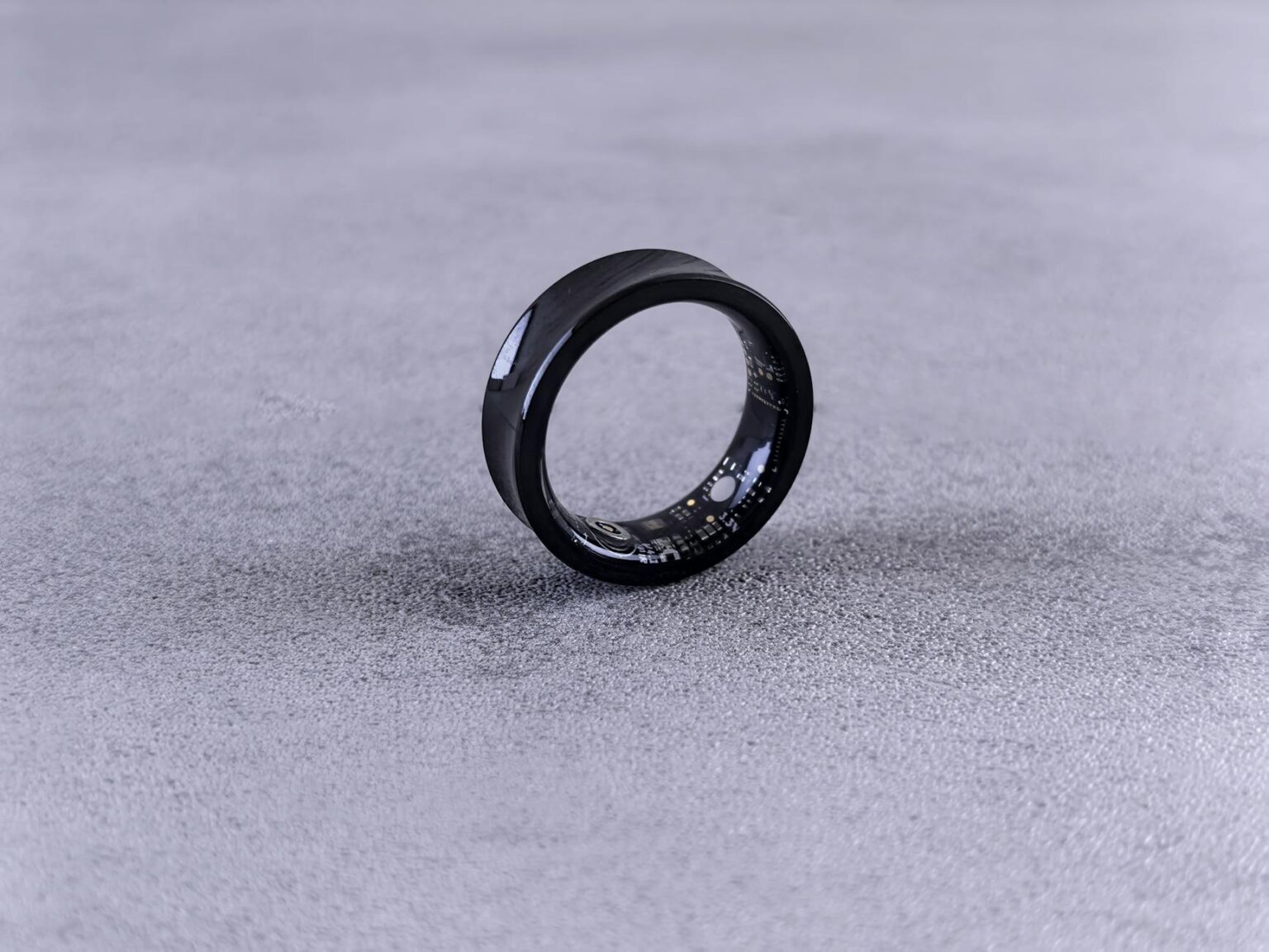 Person wearing a sleek smart ring on their finger showing the minimal, comfortable design