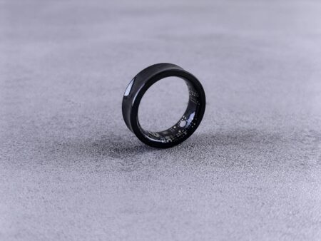 Person wearing a sleek smart ring on their finger showing the minimal, comfortable design