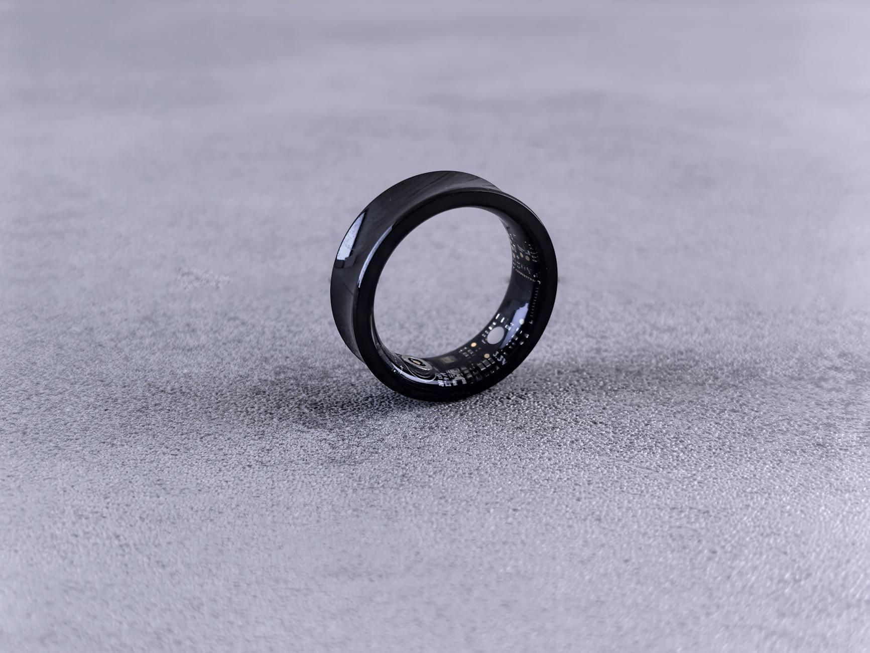 Person wearing a sleek smart ring on their finger showing the minimal, comfortable design