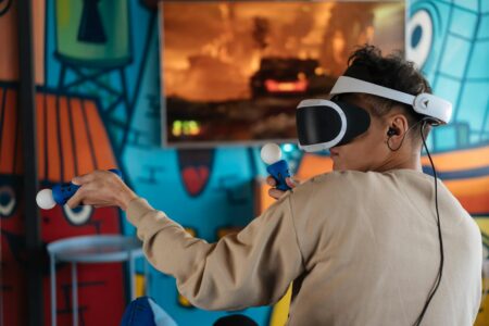 Person wearing VR headset while gaming in modern living room