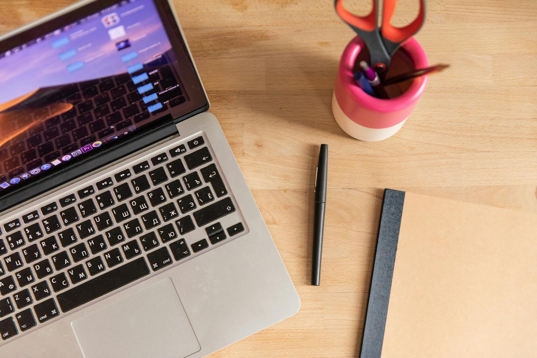 Modern laptop computer on clean desk workspace with creative tools