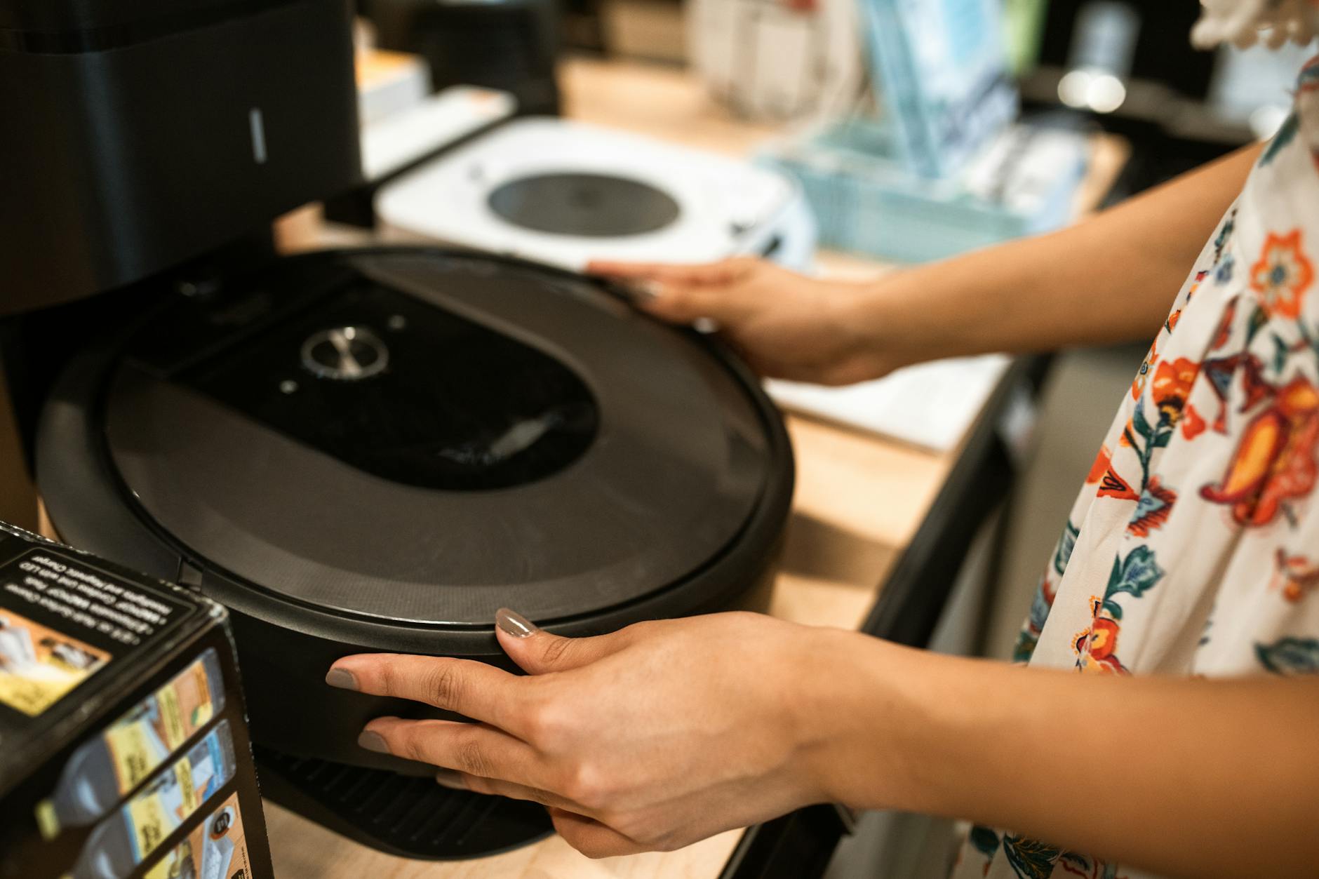 Modern robot vacuum cleaner on hardwood floor ready for cleaning cycle
