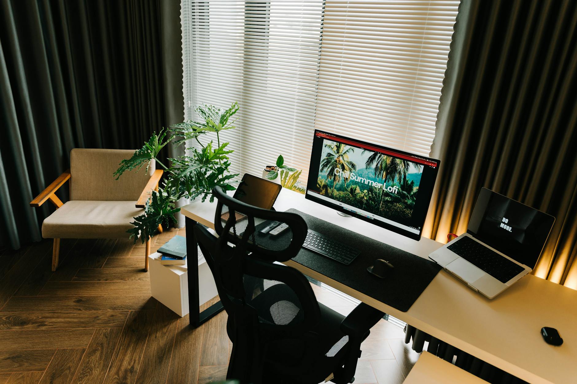 Clean home office workspace with desk, chair, and technology equipment