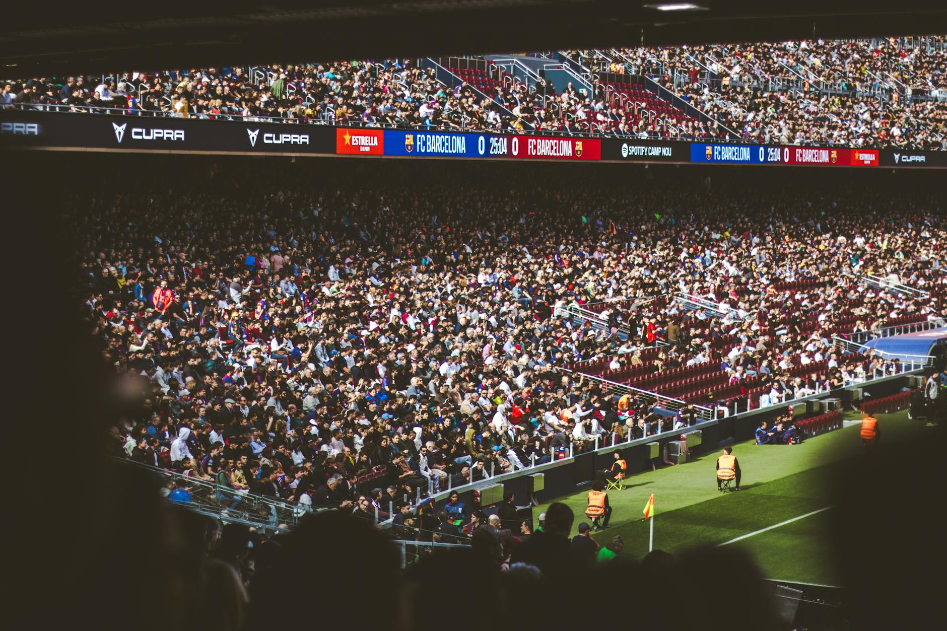 Excited crowd of sports fans cheering in stadium seats