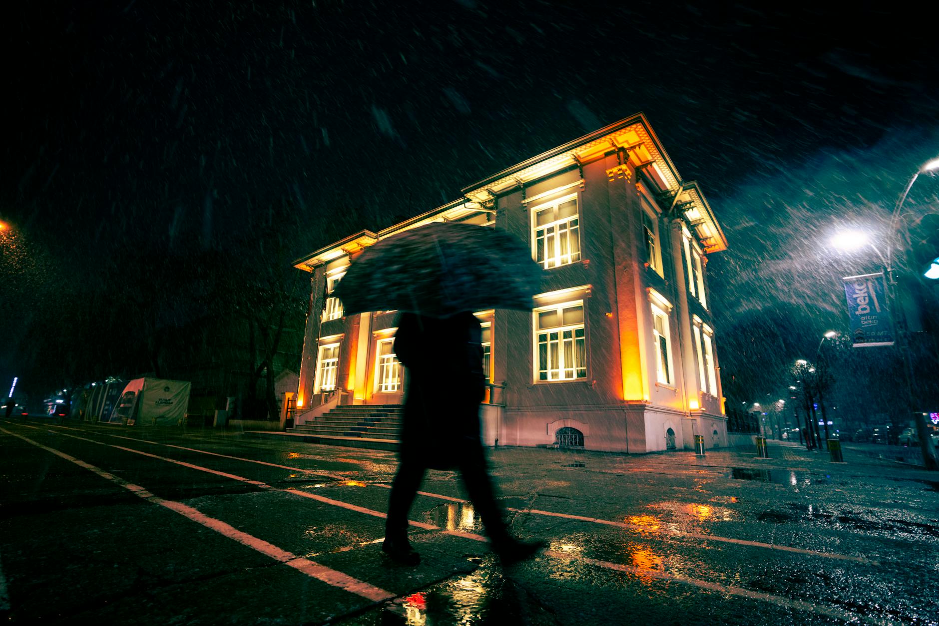Person taking photos with smartphone in low light evening setting