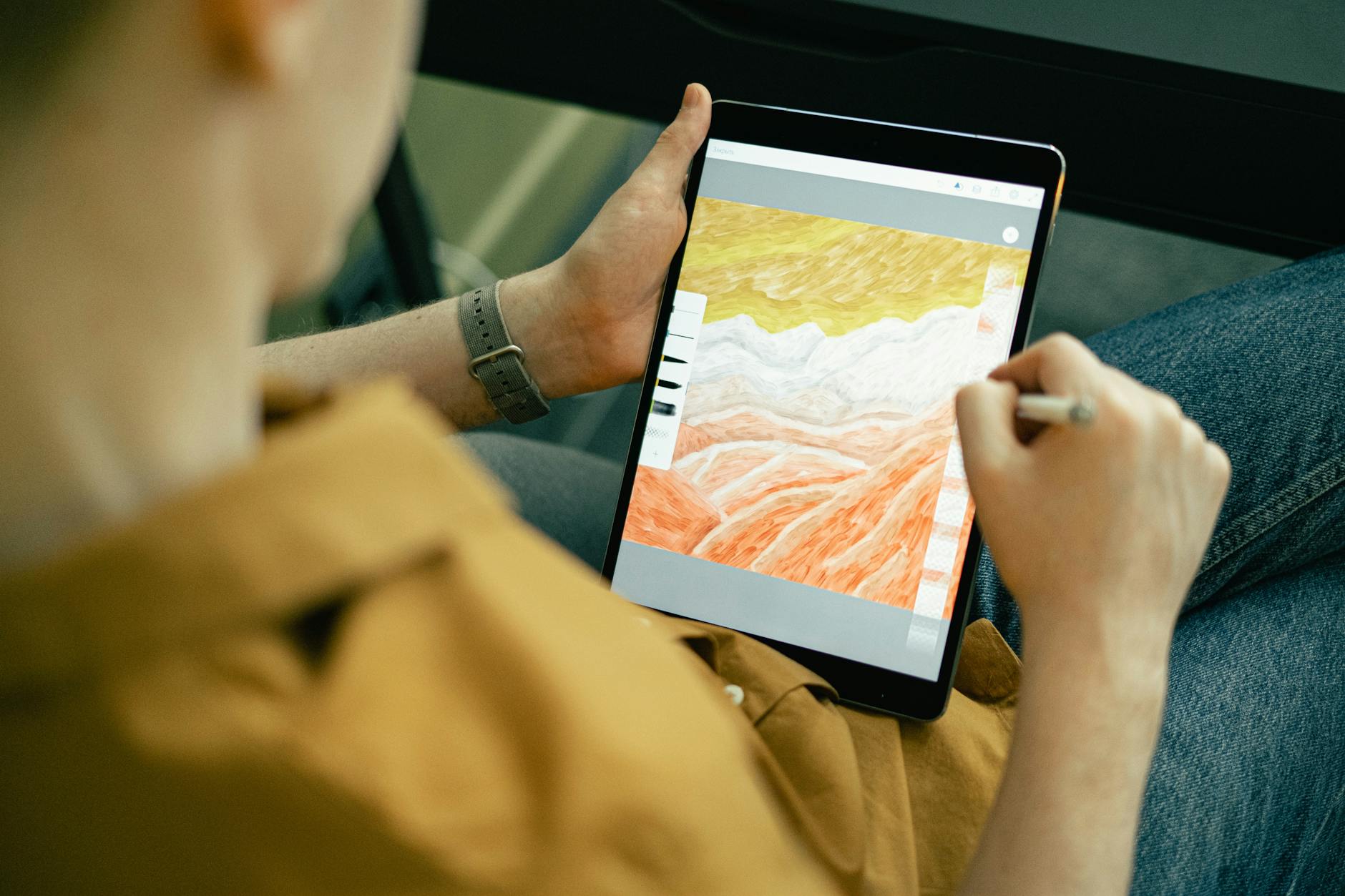 Person using stylus on tablet for digital artwork and creative design work