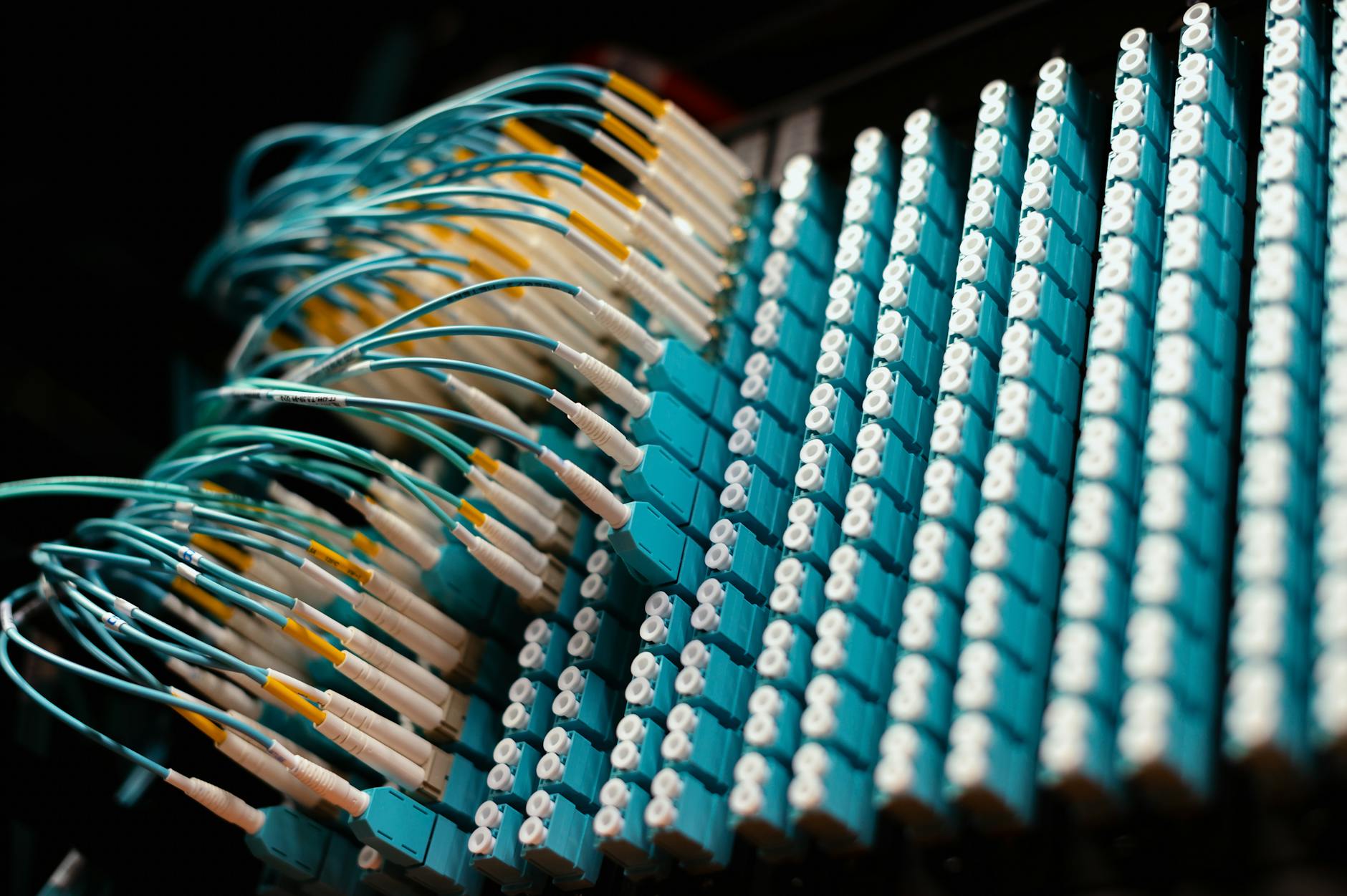 Close-up view of fiber optic cables and networking equipment in telecommunication infrastructure