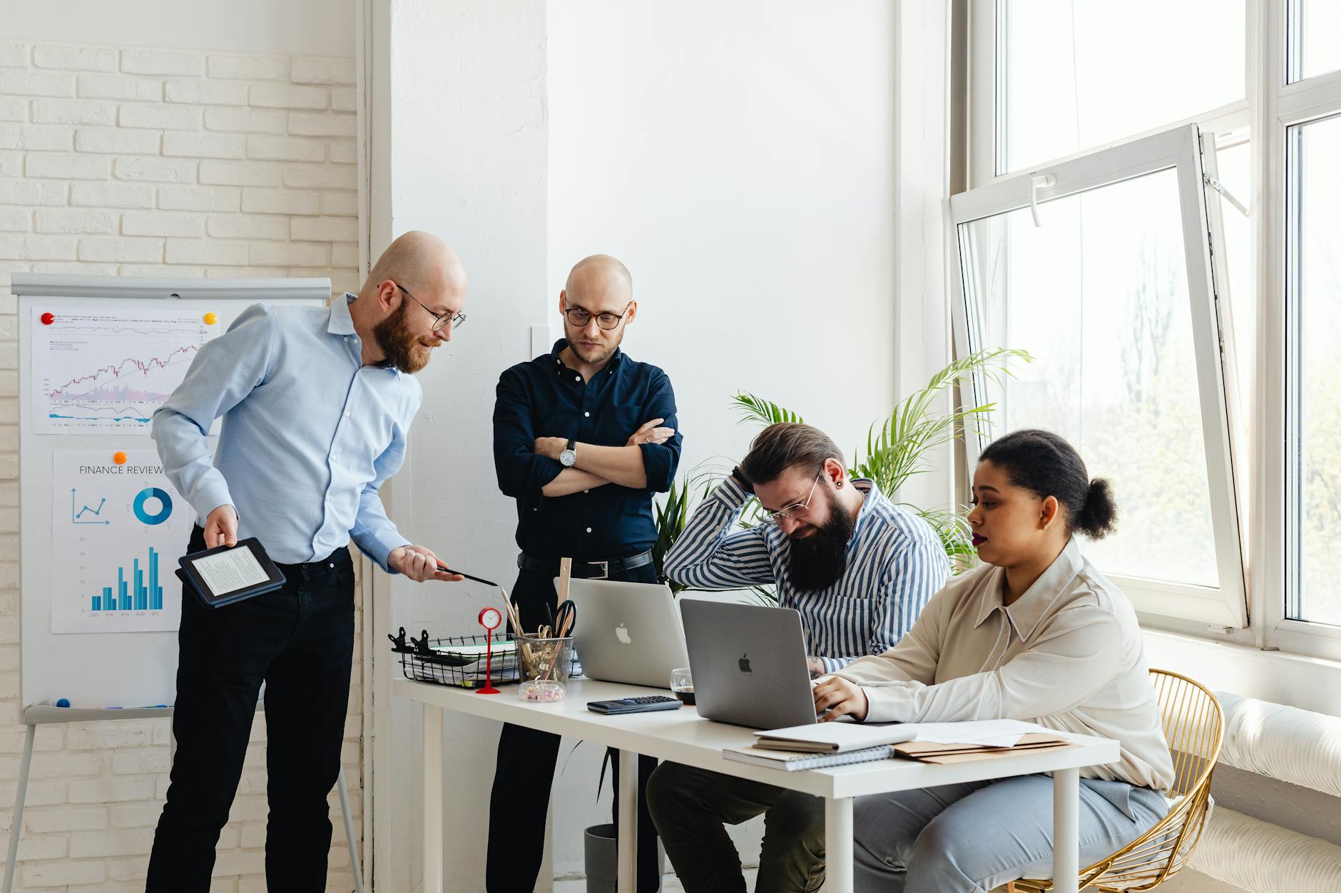 Business professionals collaborating in conference room with mobile devices