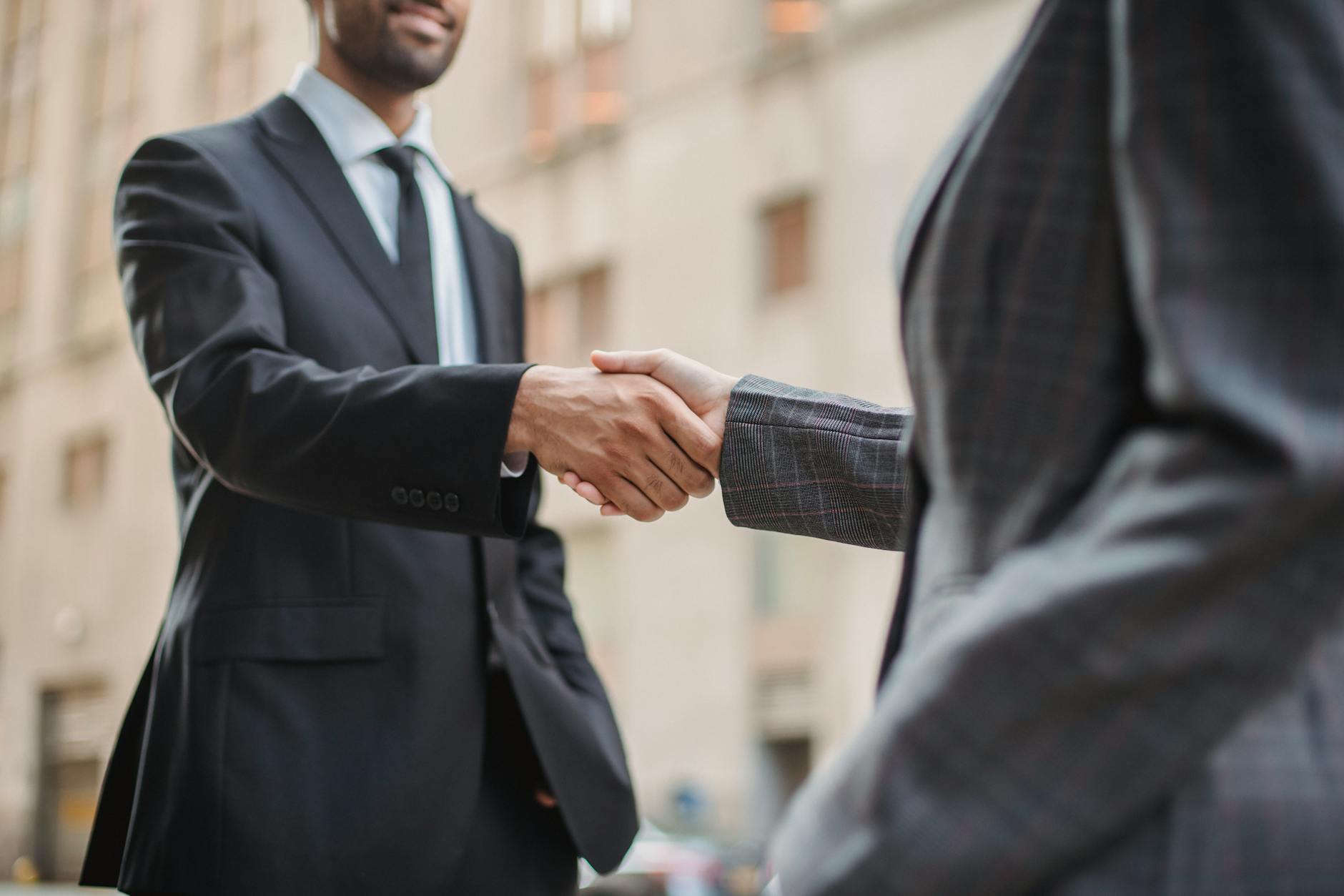 Professional business handshake representing corporate partnership agreement