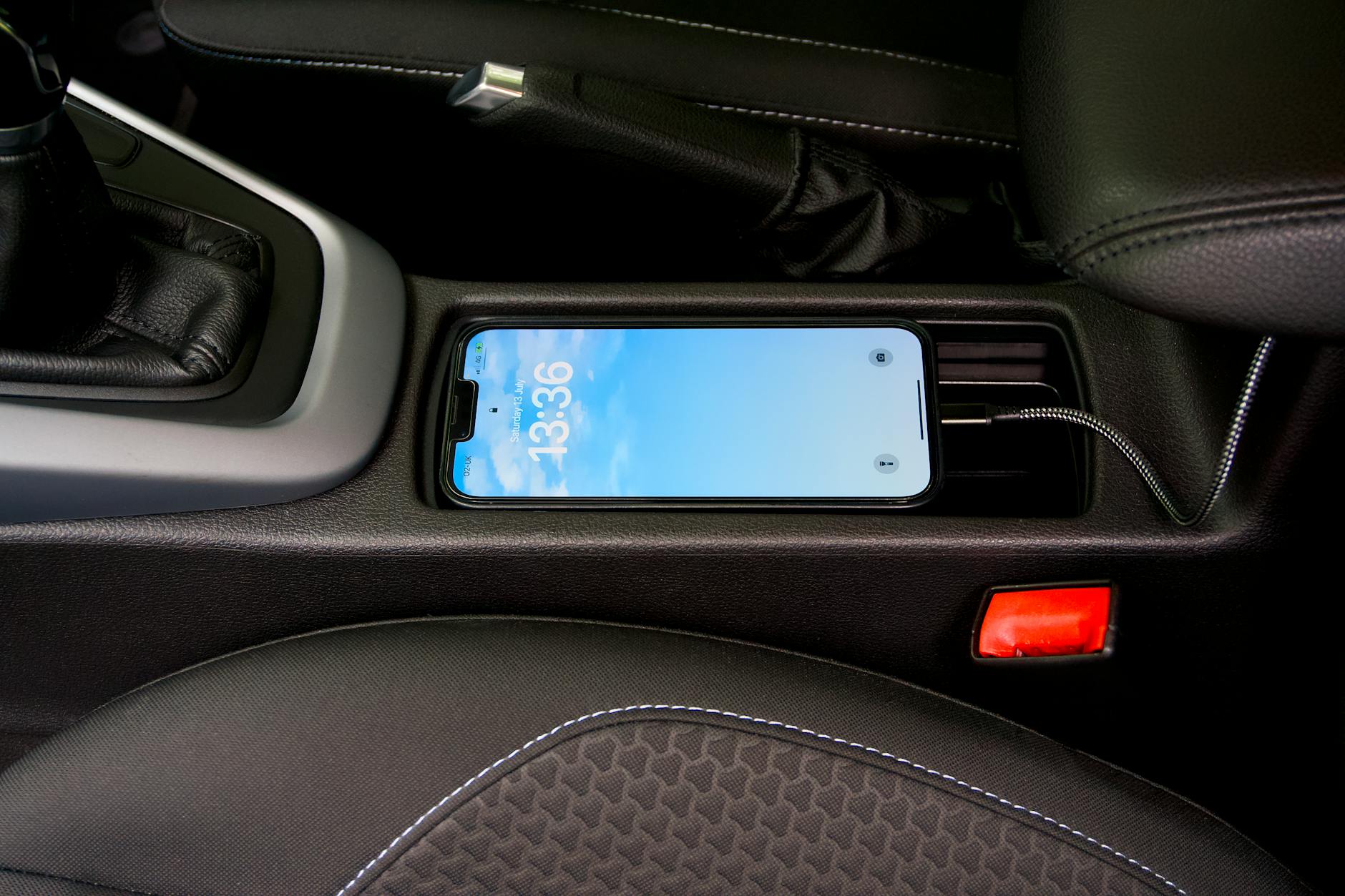 Smartphone and wireless charging case on desk showing battery and connectivity features