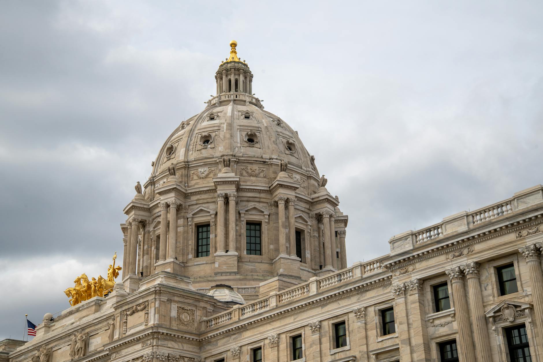 US Capitol building exterior with dome and columns during daytime