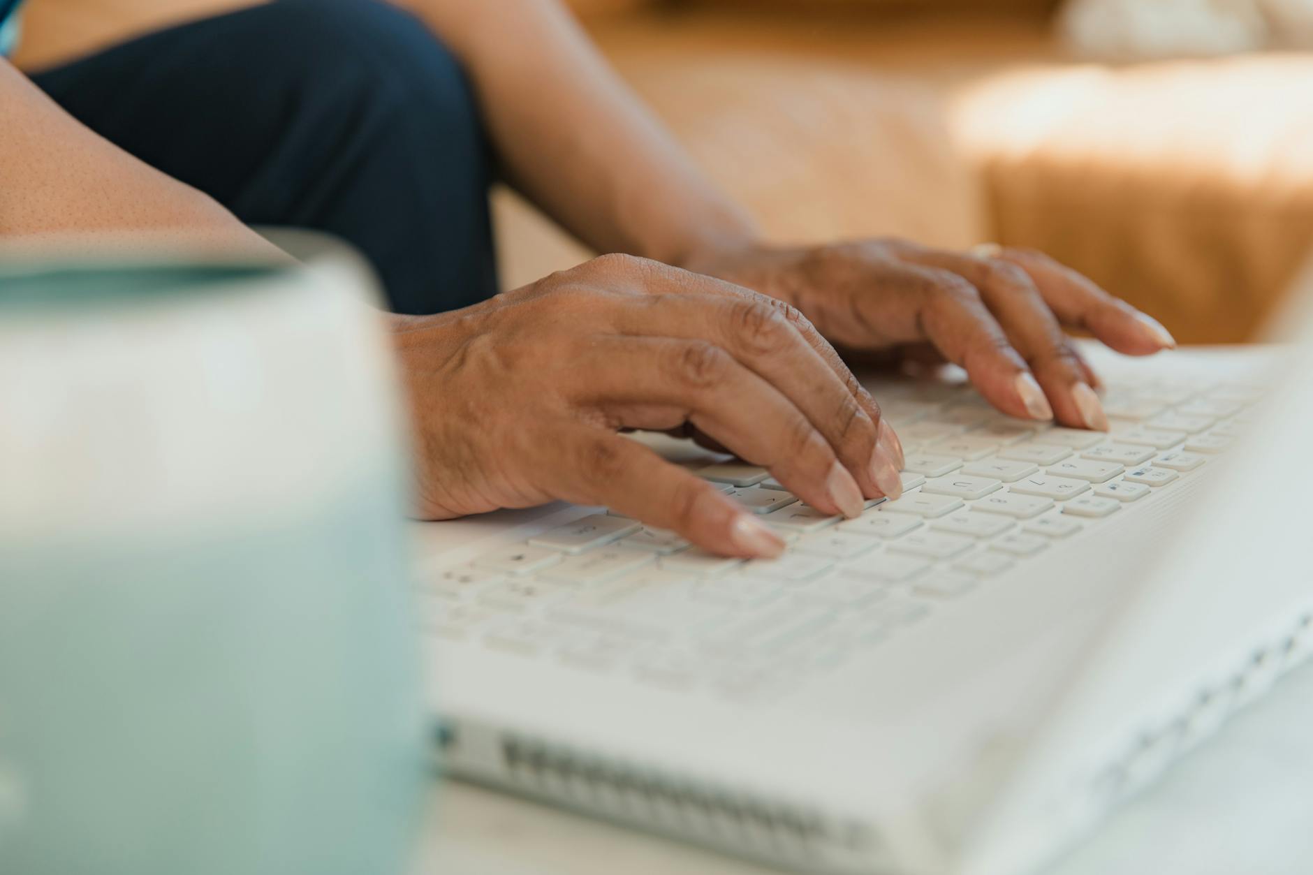 Developer's hands typing on mechanical keyboard showing proper ergonomic positioning