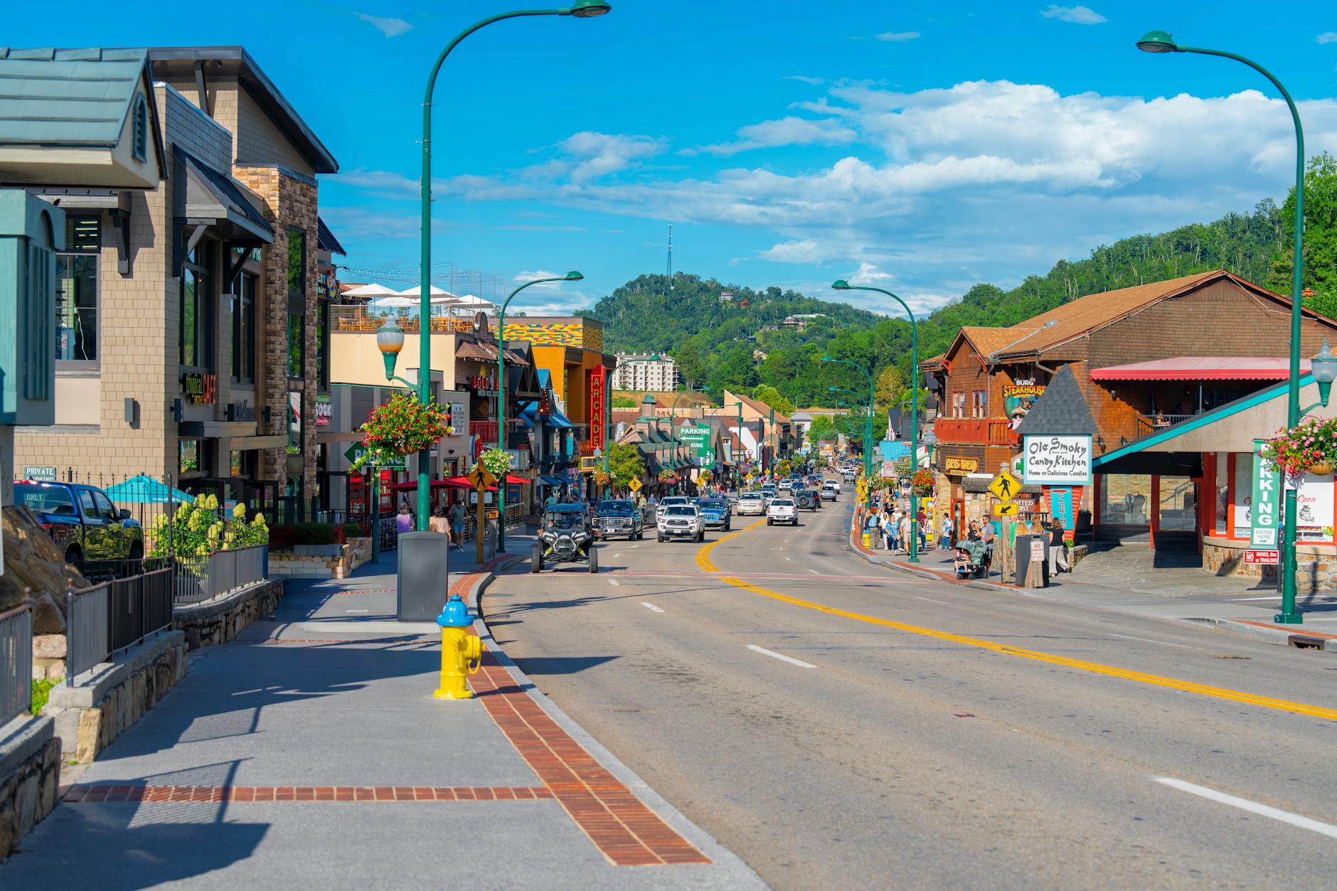Main street view of small rural town with local businesses and mountain backdrop