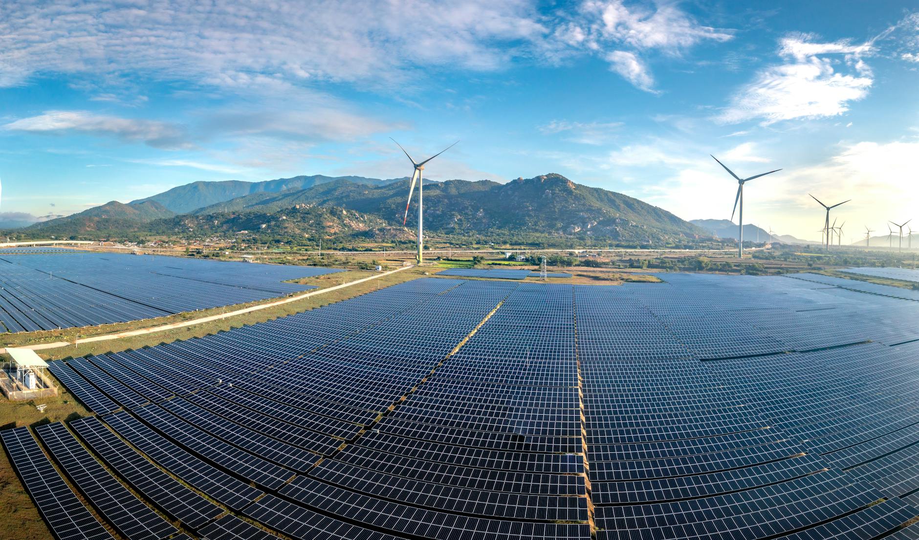 Solar panels and wind turbines representing sustainable energy solutions