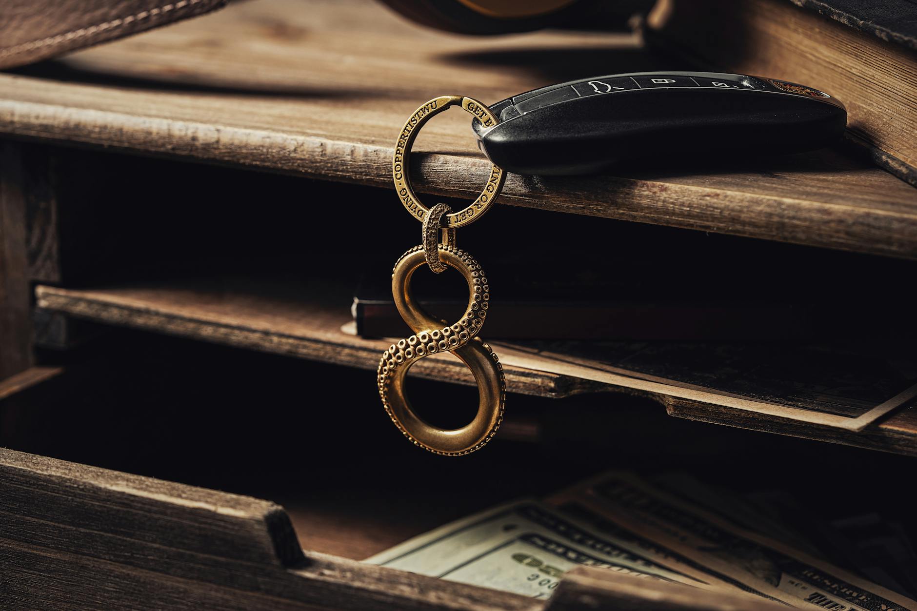 Keys and wallet on a wooden table representing commonly tracked personal items