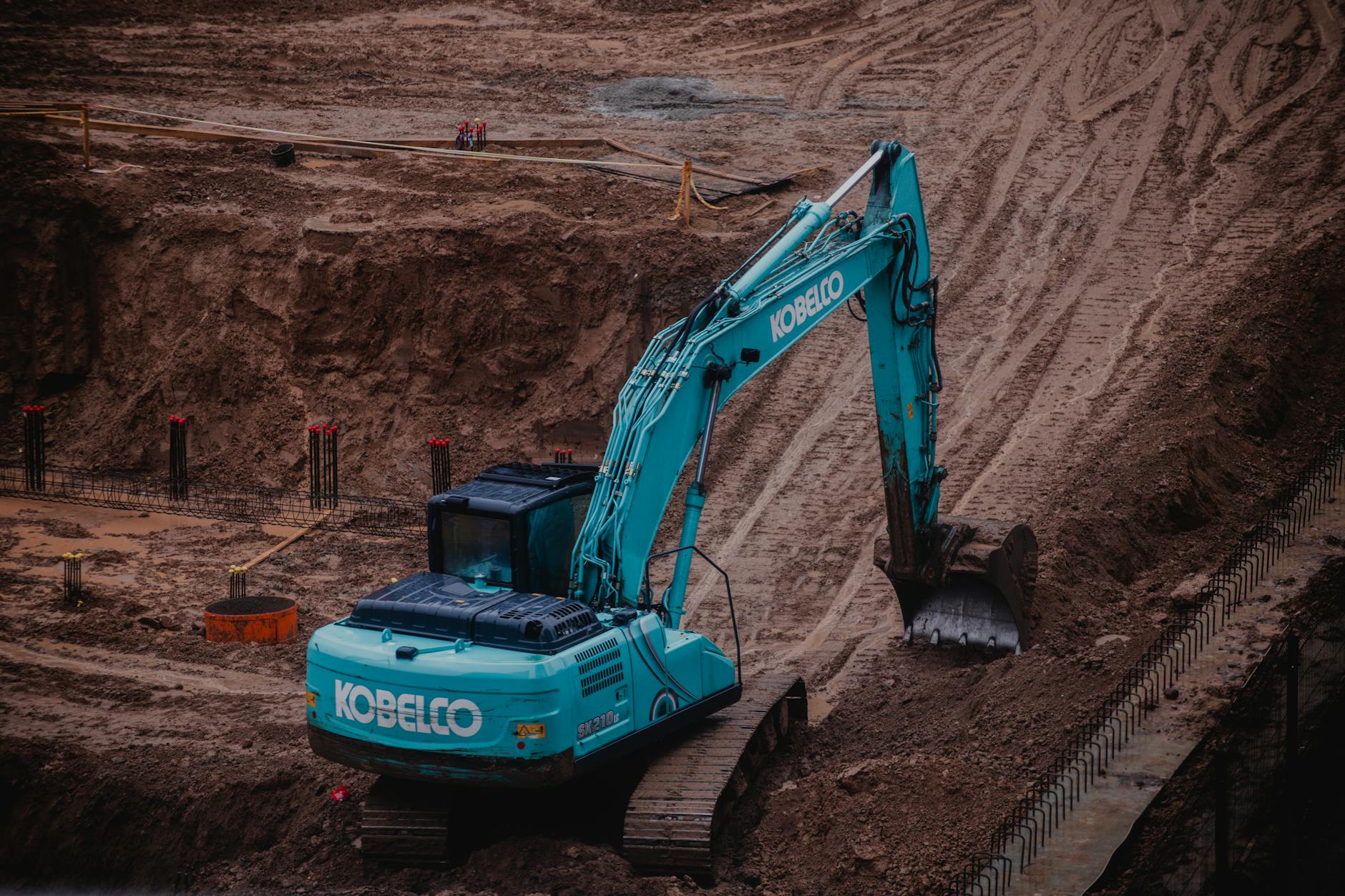 Large excavation site with heavy machinery and earthwork in progress