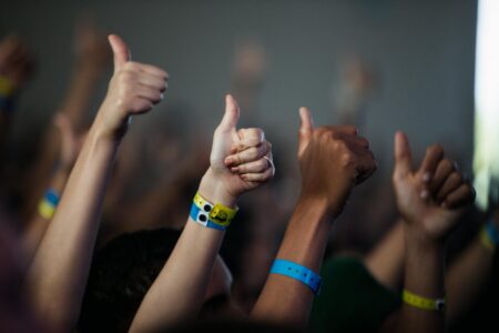 Concert attendees wearing electronic wristbands at a music venue entrance