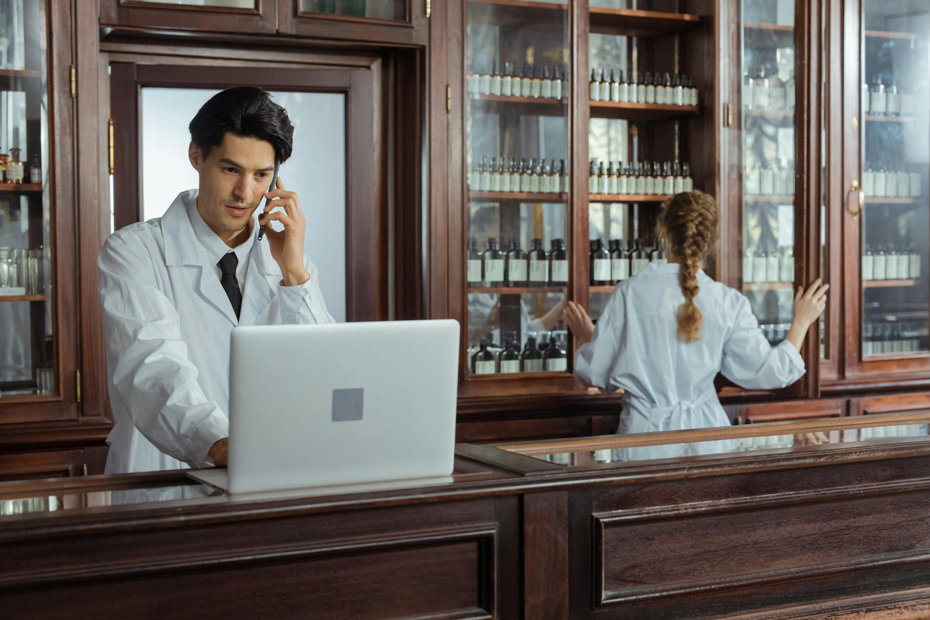Healthcare professional working with automated pharmacy technology and computer systems