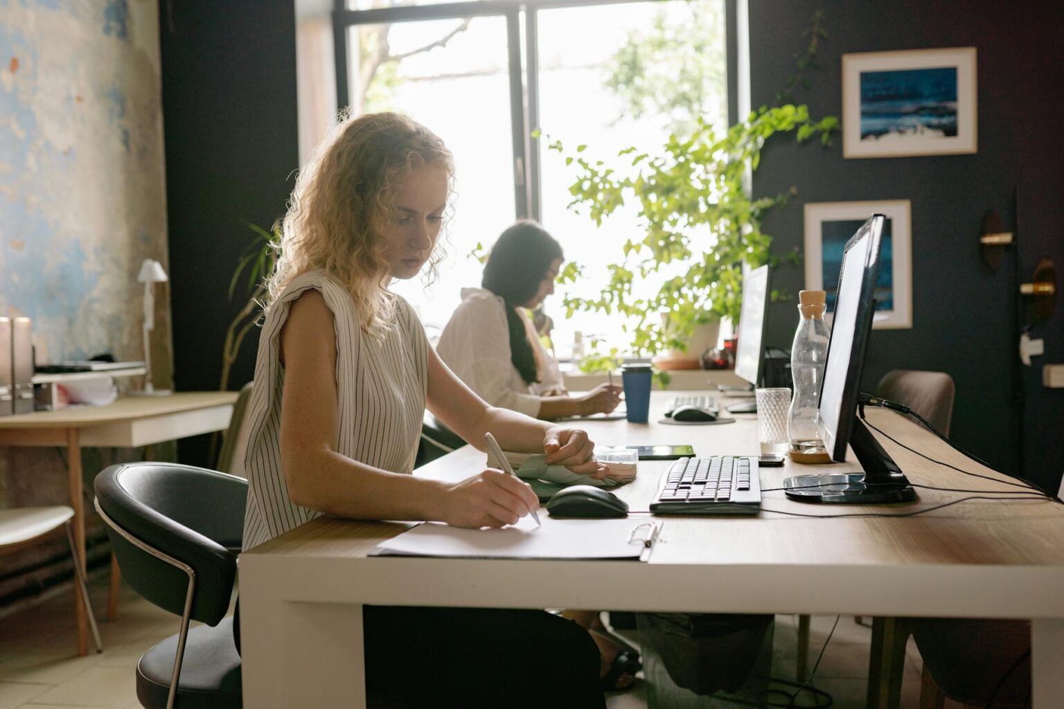 IT professionals working at computer workstations in modern office environment