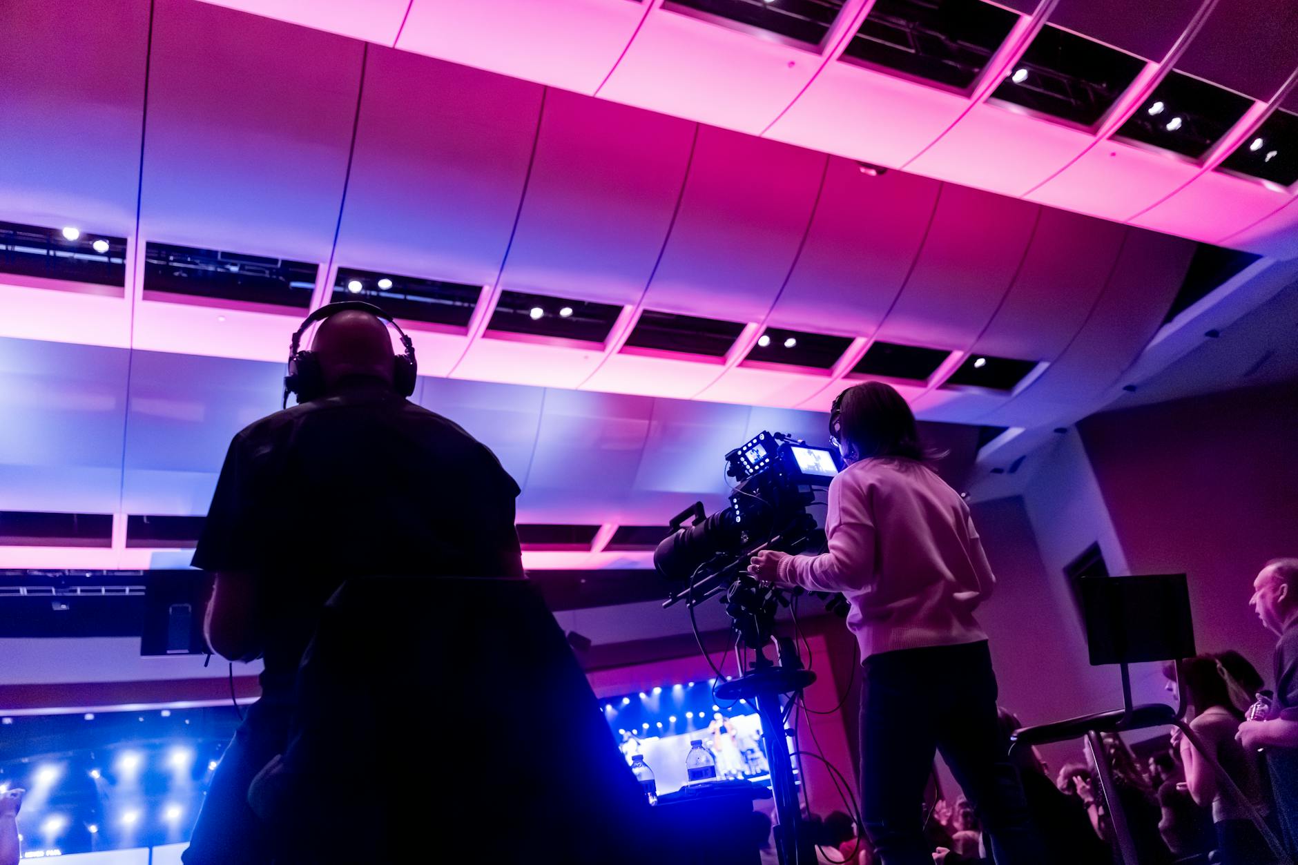 Television game show studio with bright lights and host podium