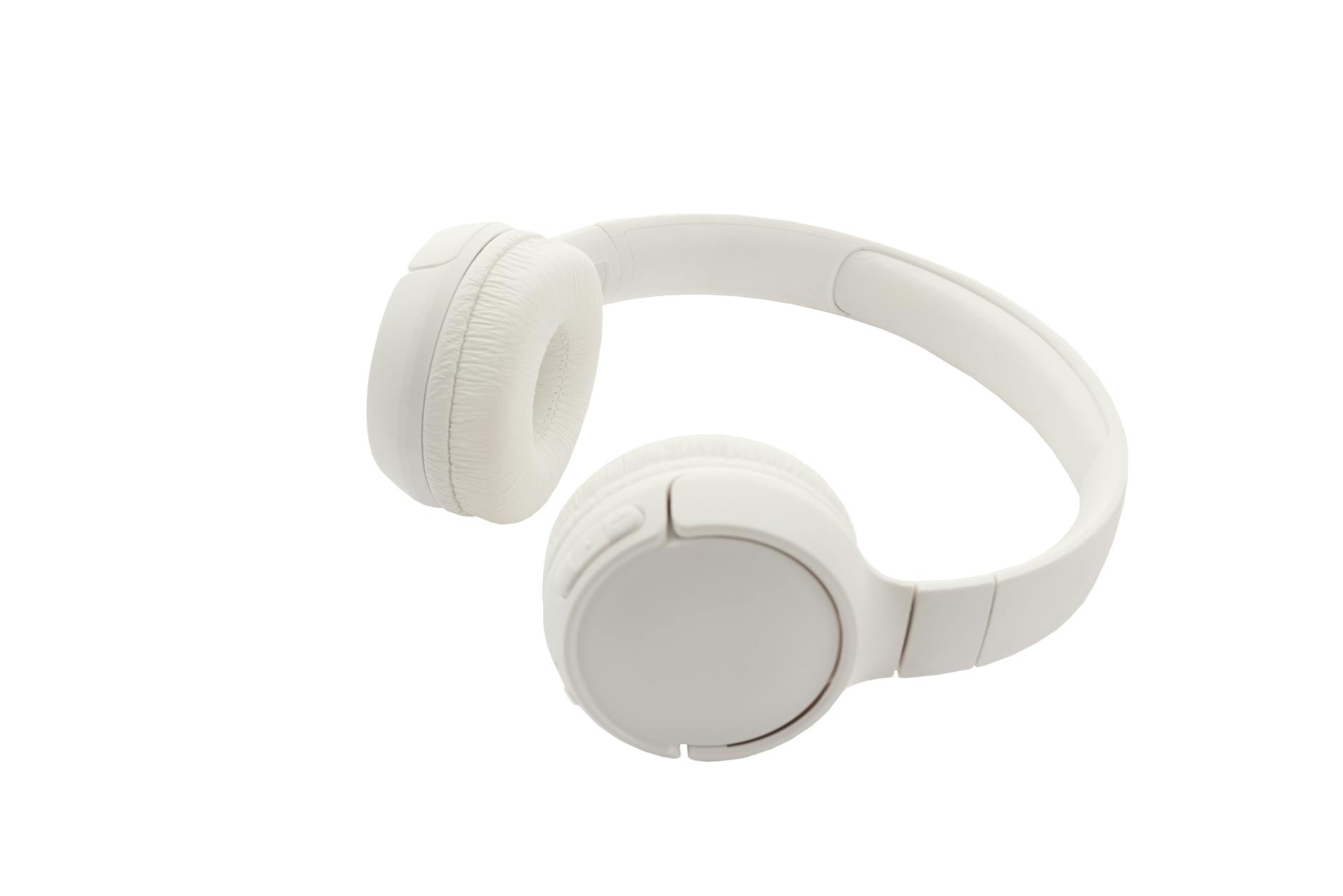 Modern wireless headphones on desk with smartphone