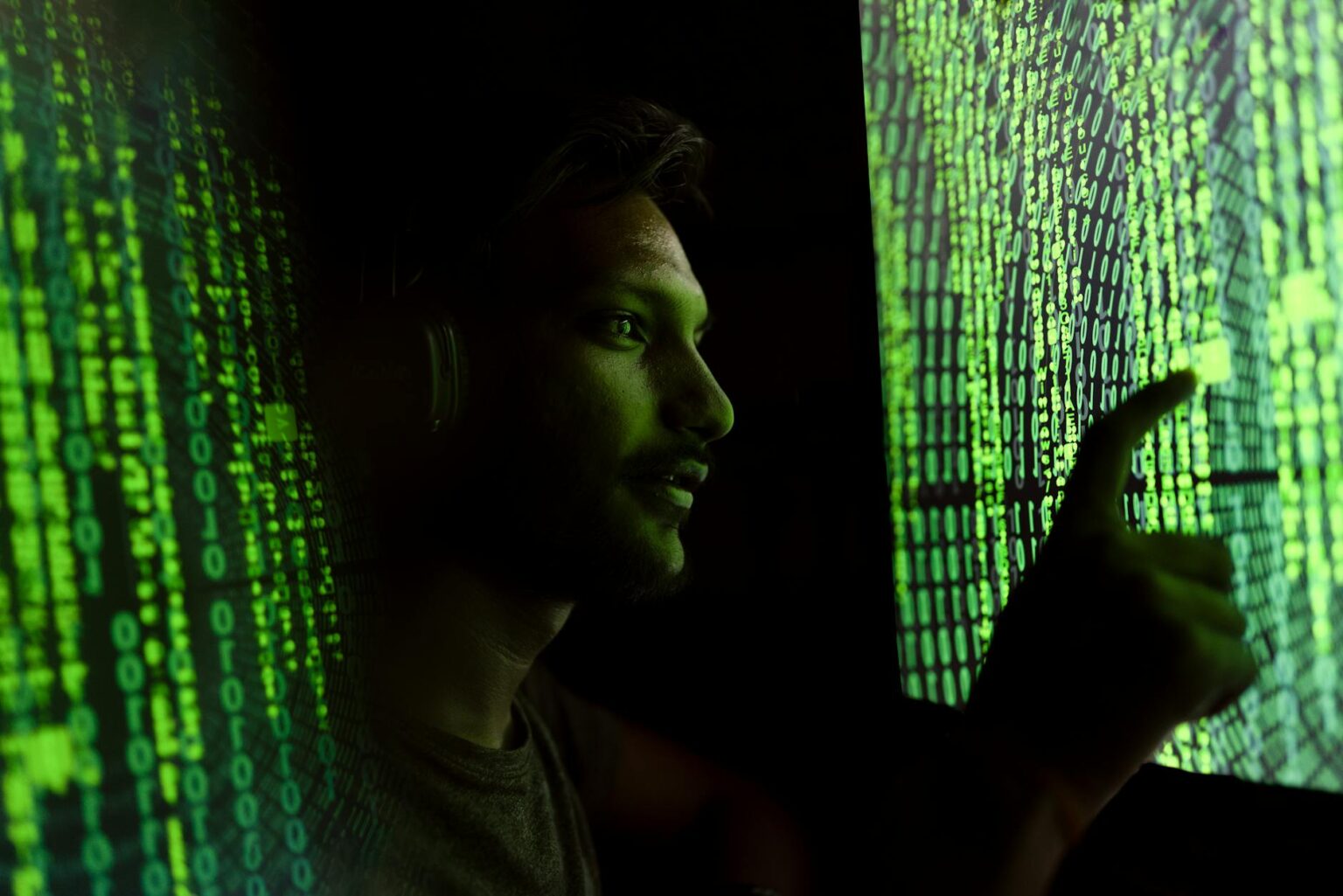 Computer screens displaying cybersecurity monitoring dashboards and network analysis