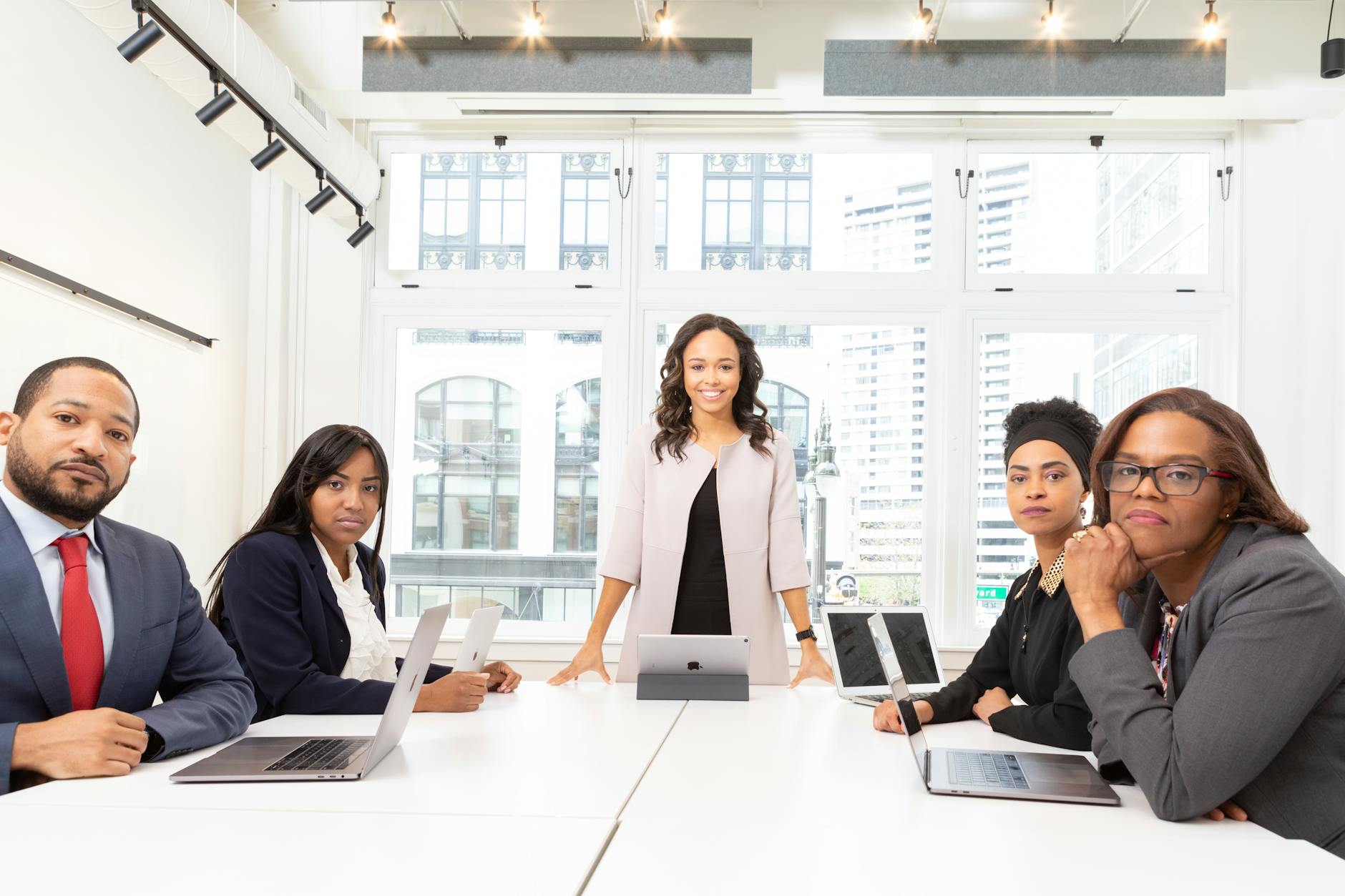 Corporate executives discussing strategy in modern boardroom