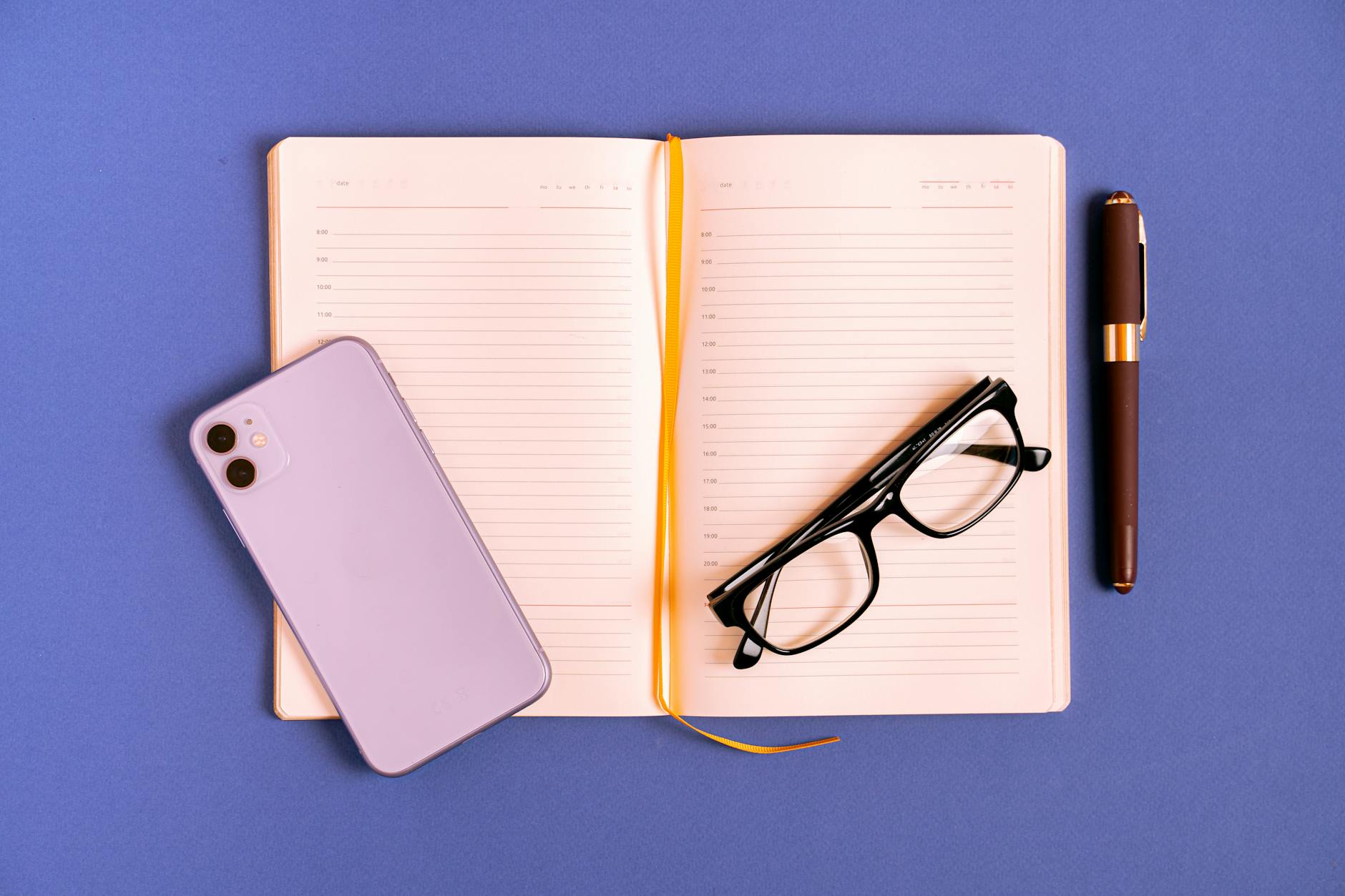Person writing on smartphone screen with journaling app interface