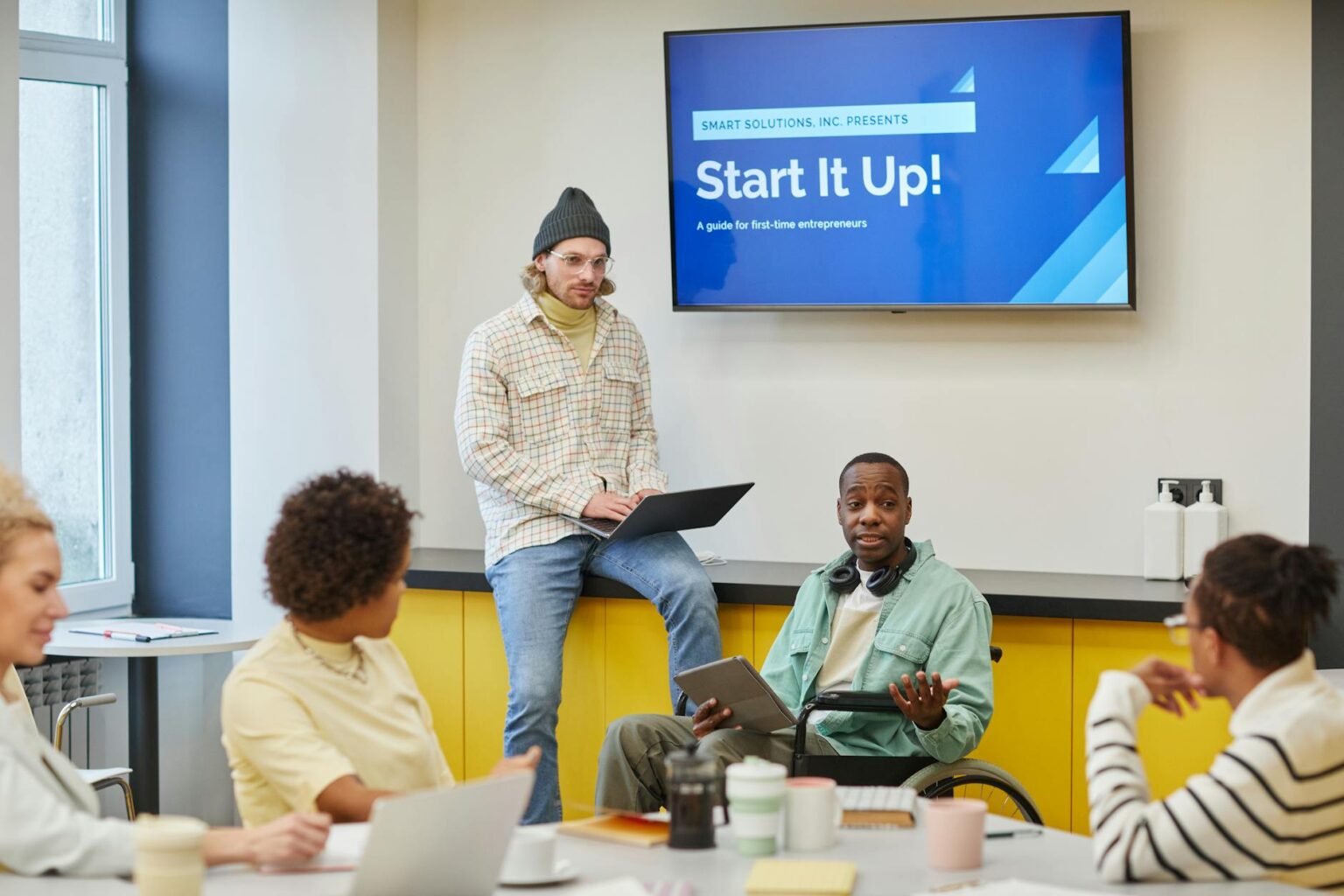 Business professionals in startup meeting discussing technology