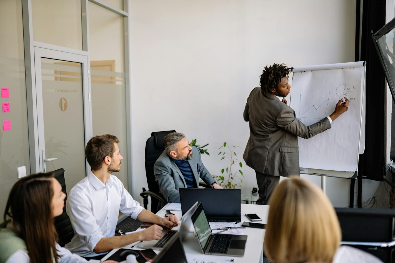 Business executives reviewing documents in modern conference room