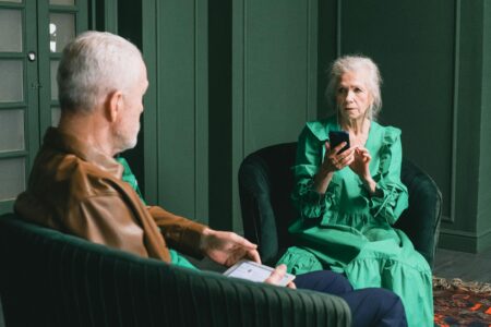 Senior citizen using smartphone showing potential vulnerability to online scams