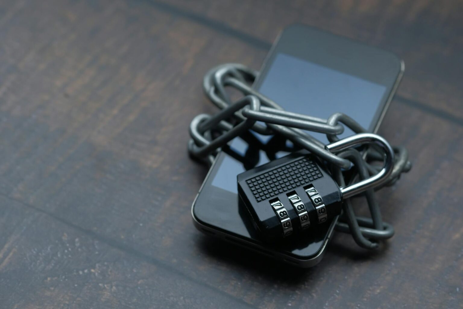 Person holding smartphone with security icons displayed on screen