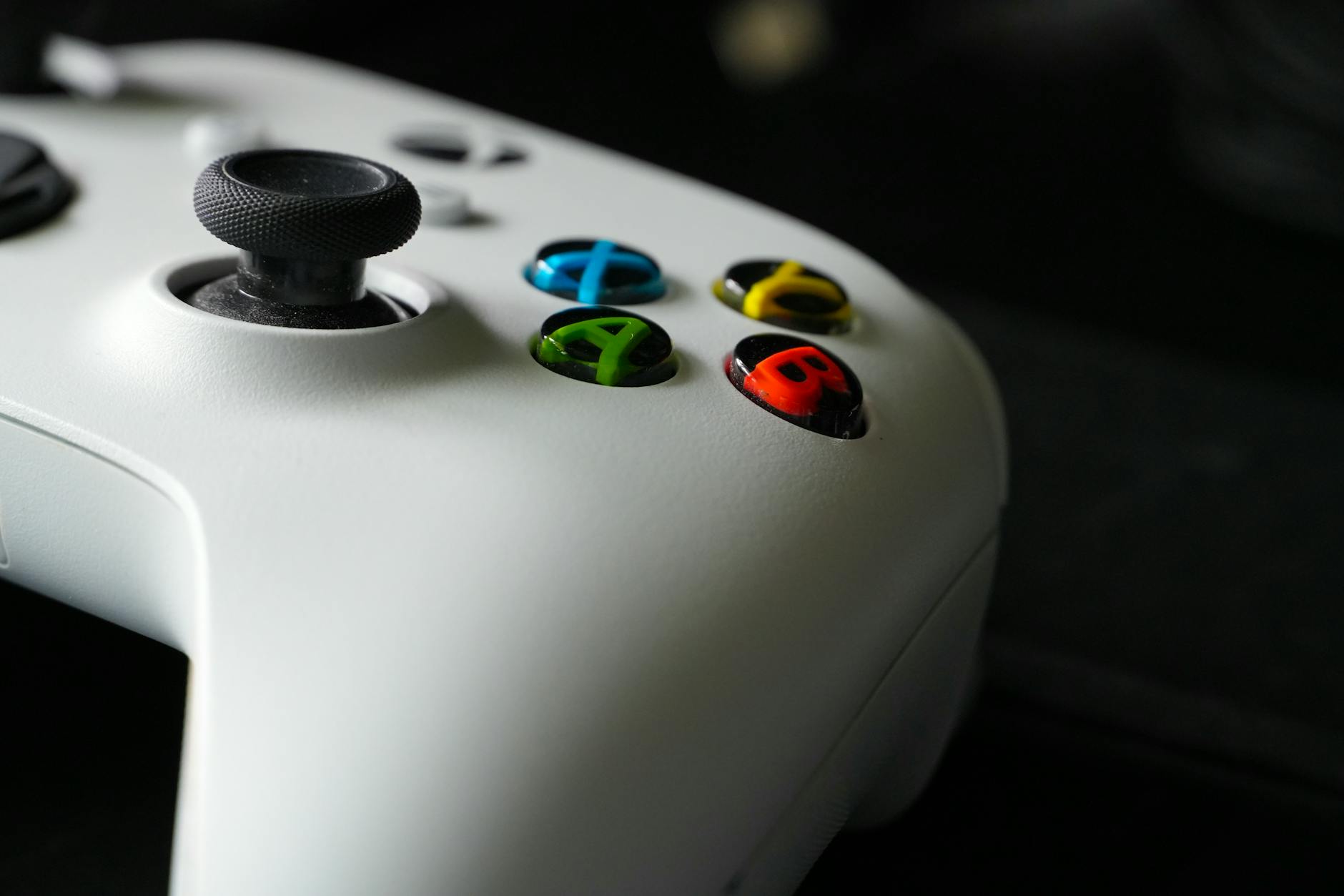 Modern gaming controller on dark surface representing video game development