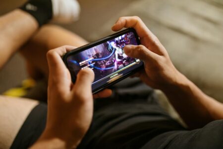 Person watching video content on smartphone screen
