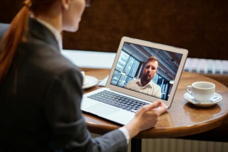 People participating in a video conference call on computer screens