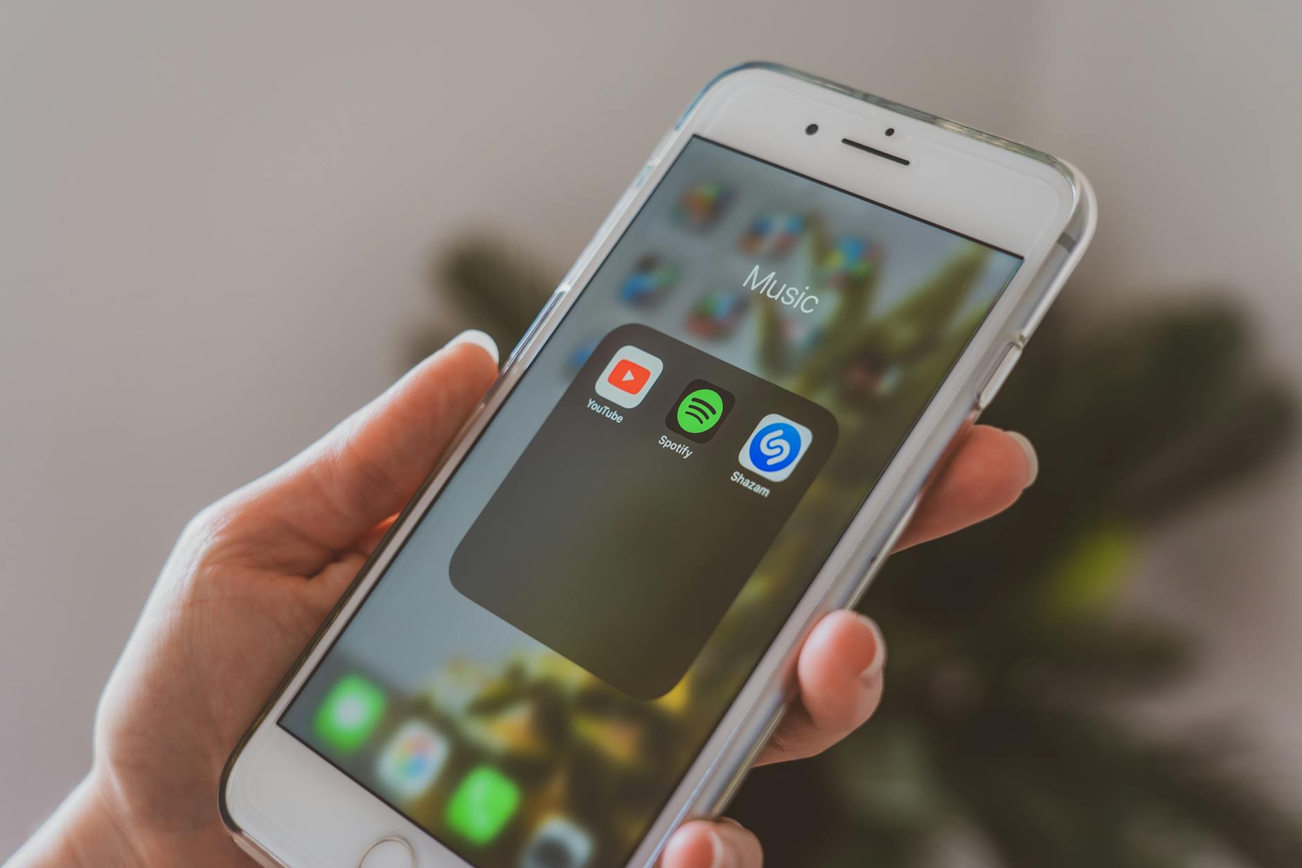 Person using music streaming app on smartphone