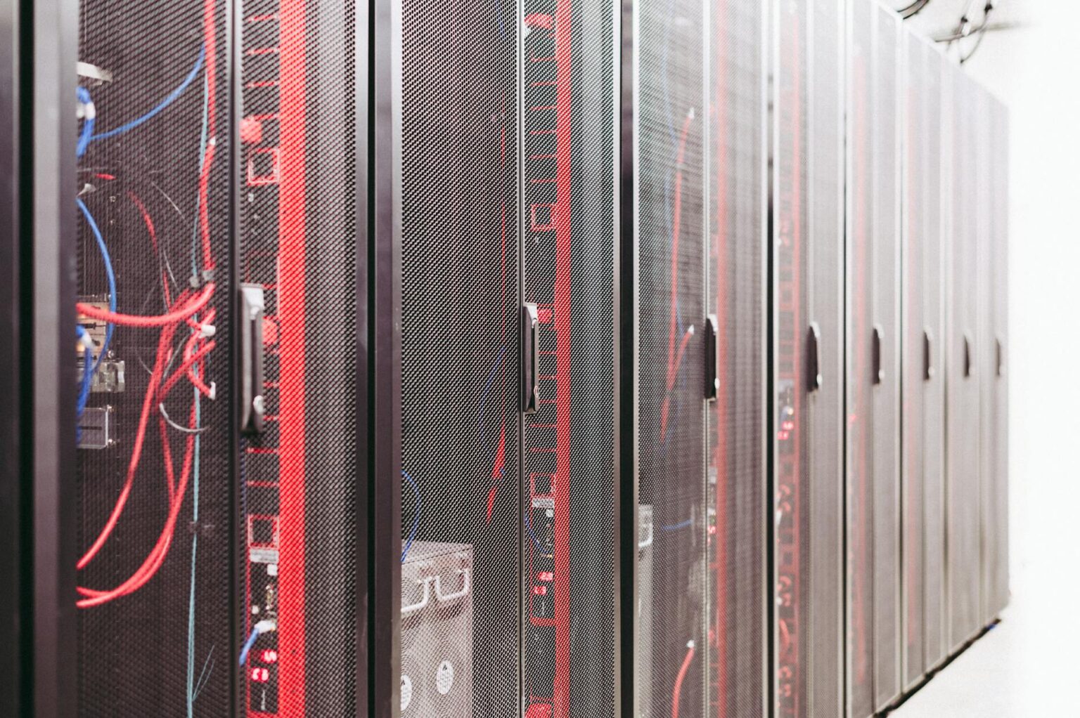 Rows of illuminated server racks inside a large data center facility