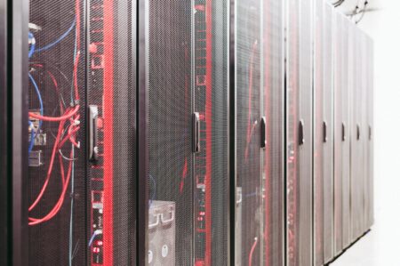 Rows of illuminated server racks inside a large data center facility