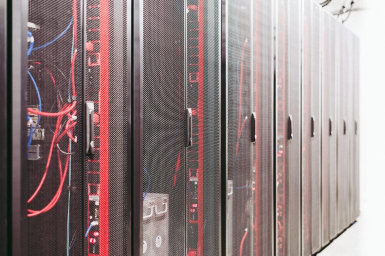 Rows of illuminated server racks inside a large data center facility