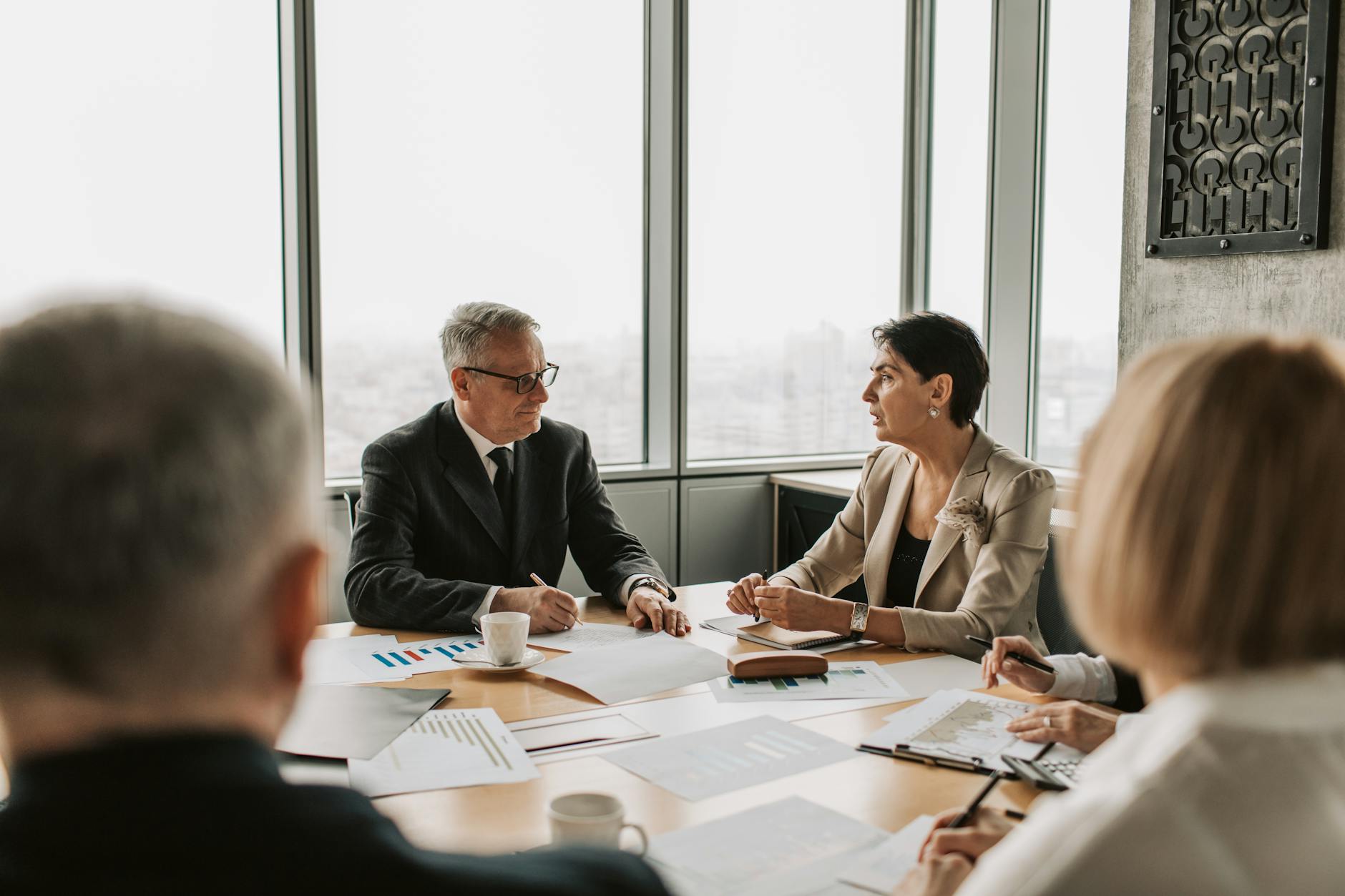 Corporate boardroom with empty chairs around conference table