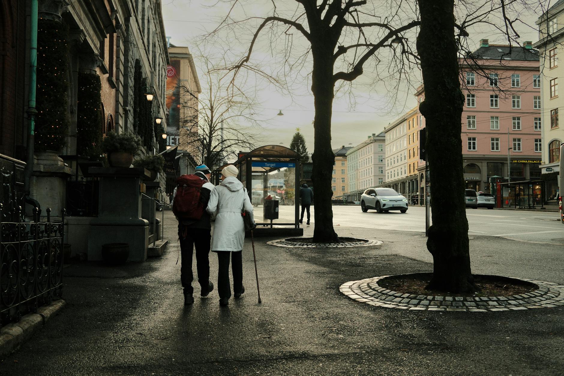 Person walking on busy urban street wearing headphones